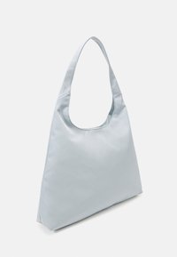 Bolso de hombro de tela suave en azul claro, con un asa curva y suave y una abertura amplia, que presenta un diseño minimalista y sin estructura.