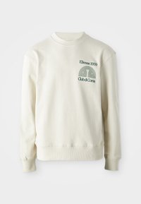 Krémová mikina s ribovaným límcem a manžetami; obsahuje zelené vyšívané logo "Ellesse 1959" s designovými prvky na hrudi.