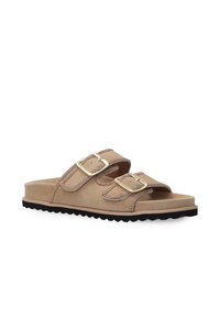 Tan suede slide sandals with two adjustable straps featuring gold buckles, a contour footbed, and a textured black rubber outsole.