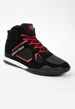 Schwarze High-Top-Sportschuhe mit roten Schnürsenkeln, aus Wildleder und Netzmaterialien, mit verstärkter Zehenkappe, Logopunkten und einer Gummisohle.