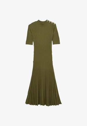 Strikket kjole i olivengrøn, med korte ærmer, ribbet øverste del og plisseret nederdel. Fremhævet med knapper på skulderen.