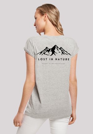 Gray short-sleeve t-shirt featuring a black mountain graphic and text "LOST IN NATURE" on the back. Soft texture and relaxed fit design.