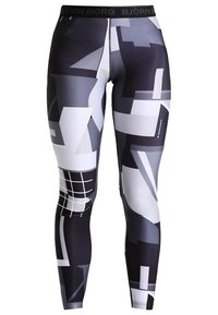 Leggings neri e grigi con motivo, realizzati in tessuto elasticizzato, caratterizzati da forme geometriche, un design a griglia e una vita nera con branding.