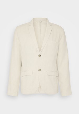 Blazer in lino beige chiaro con due tasche frontali, revers a punta e due bottoni. Tessuto testurizzato con una vestibilità comoda.