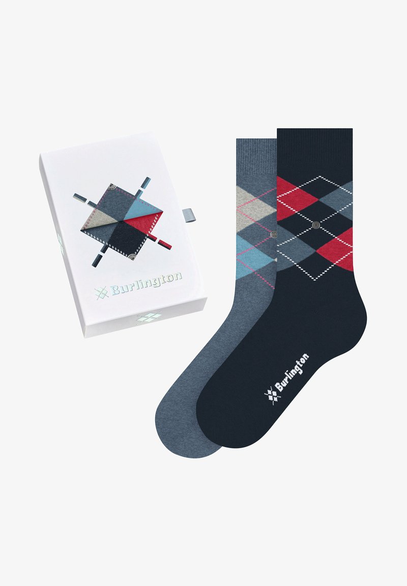Argyle-patterned socks in navy blue, gray, and red shades, packaged in a white box featuring a contrasting design and logo.