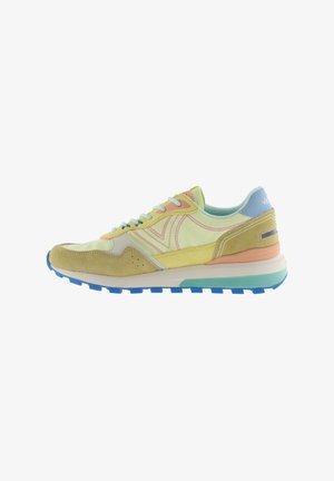 Low-top athletic sneaker with suede and fabric panels in pastel yellow, blue, peach, and beige with white laces and a textured blue sole.