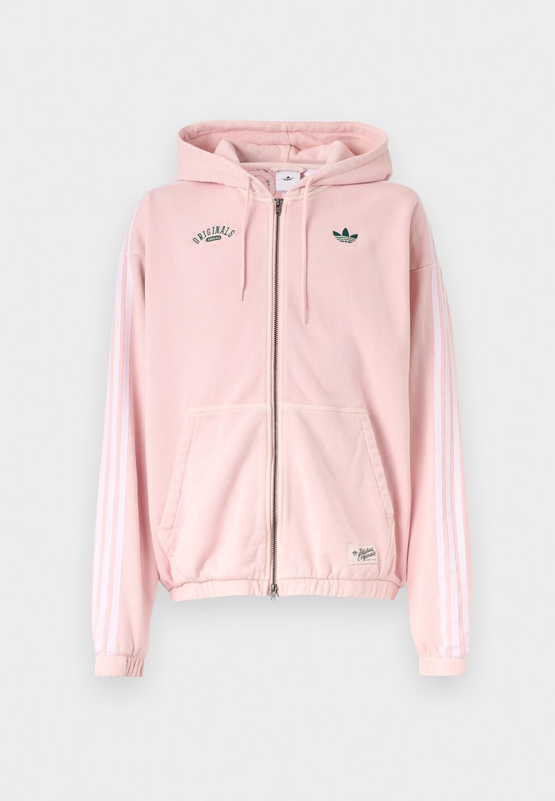 Sweat à capuche zippé rose clair avec manches blanches à trois bandes, poches avant et logos verts Adidas Originals sur la poitrine.