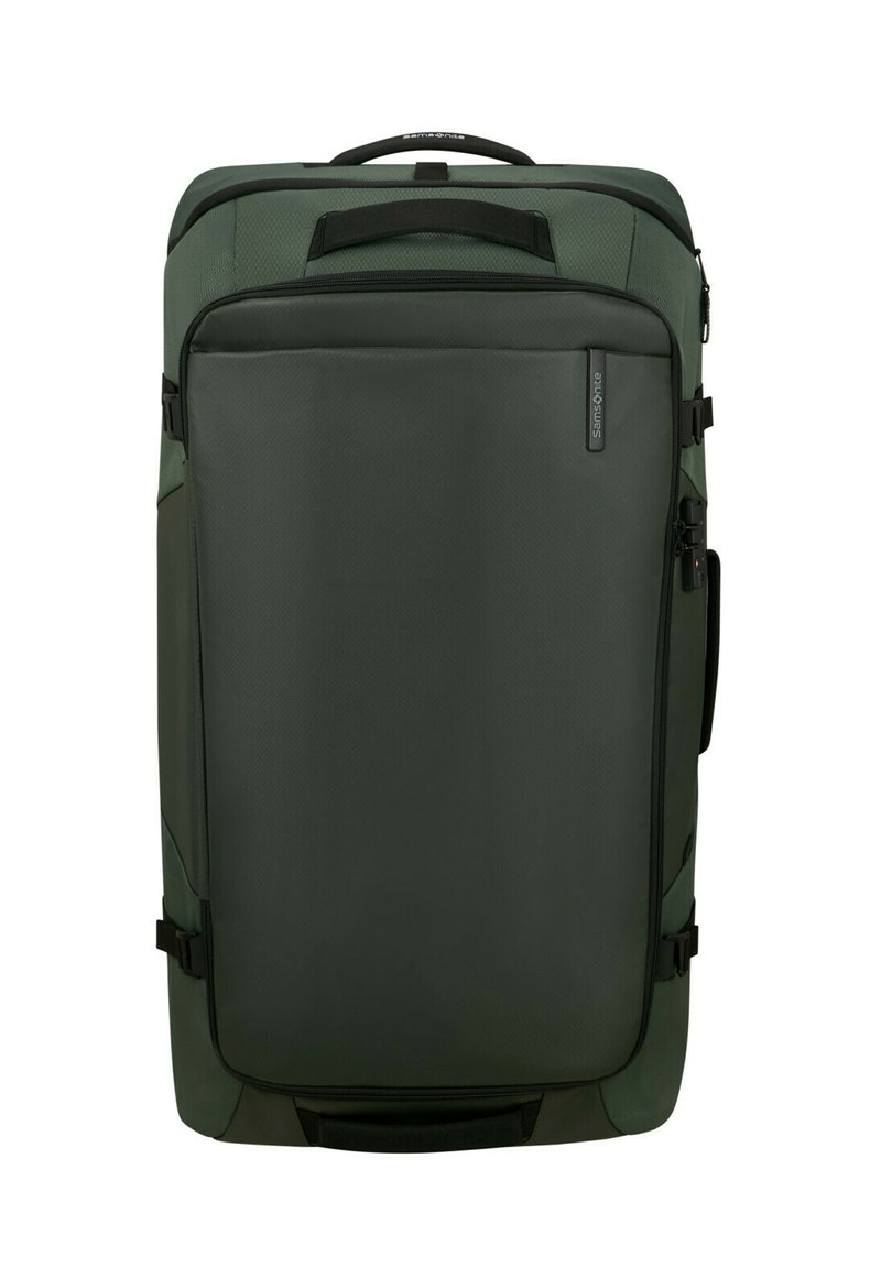 Green fabric suitcase with a rectangular shape, featuring a front zipper pocket, top handle, and side compression straps for secure closure.