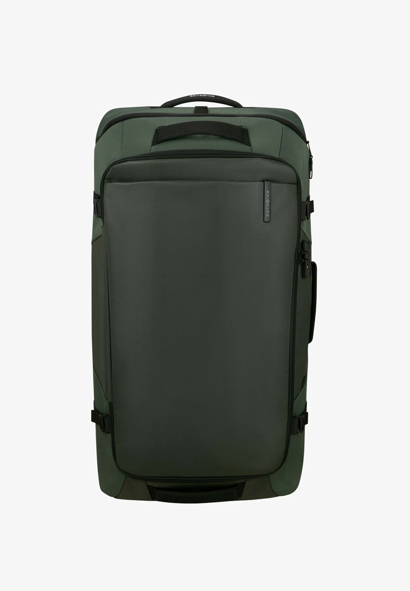 Green fabric suitcase with a rectangular shape, featuring a front zipper pocket, top handle, and side compression straps for secure closure.