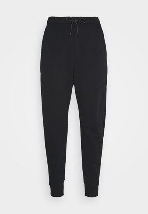 Schwarze Jogger-Hosen aus weichem Material, mit einem elastischen Bund und schmal zulaufenden Beinen. Enthält Seitentaschen mit gebogenen Nähten.