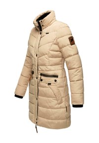 Doudoune beige avec un col montant, des coutures horizontales, des poches avant, un patch logo marron sur la manche et des poignets de manche noirs.