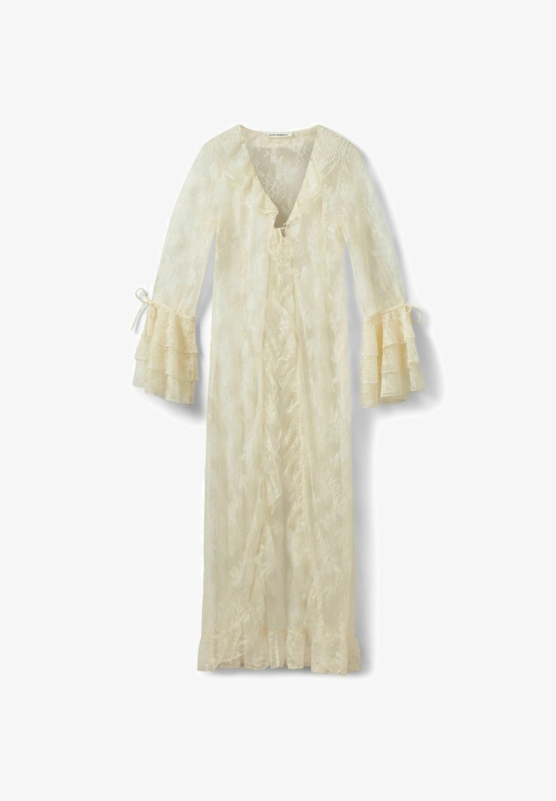 Longue robe crème en dentelle avec décolleté en V, nouée à l'avant, manches évasées à volants, et ourlet à volants.