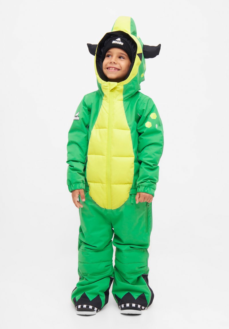 Groene puffer sneeuwpak met een gele buik, dinosaurusontwerp, zwarte hoorns en speelse accenten. Voorzien van een rits aan de voorkant en een oversized pasvorm.