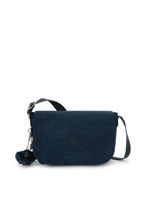 Navy crossbody bag made of textured fabric, featuring a flap closure, logo emblem, and a fuzzy charm accessory. Adjustable strap included.