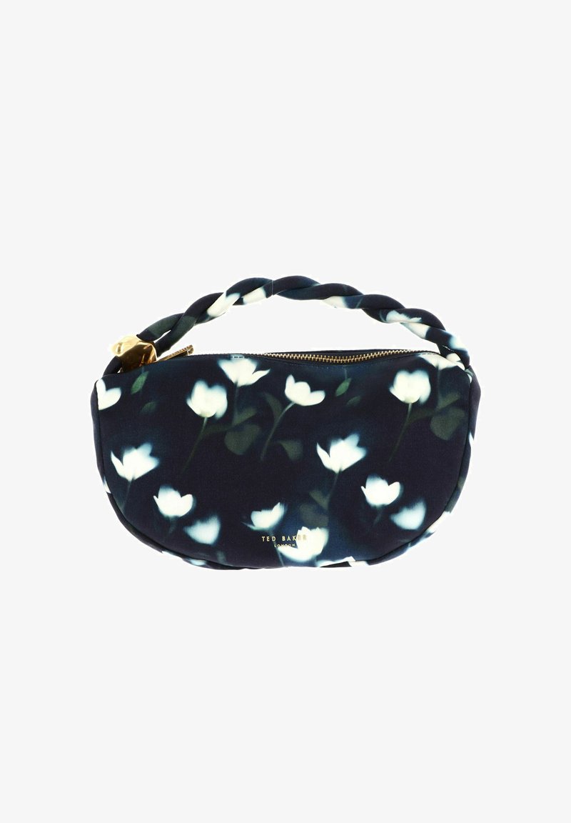 Petit sac à main en tissu noir avec un motif floral blanc, poignée torsadée, fermeture éclair dorée, et logo Ted Baker London en lettres dorées.