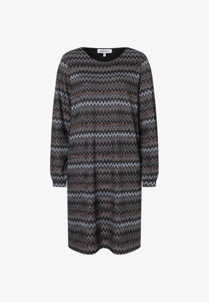 Kneeslanges Kleid in Schwarz mit einem Zickzackmuster in Blau, Braun und Bronze. Runder Ausschnitt und lange Puffärmel. Weicher Strickstoff.