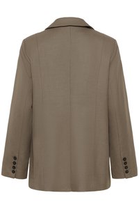 Brun blazer med skrået revers, struktureret silhuet, åbning bagpå og fire sorte knapper på hver manchet. Glat, tekstureret stof.