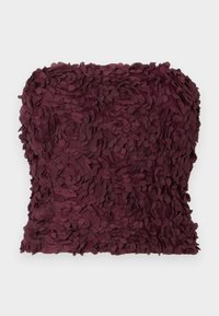 Maroon strapless top featuring a textured surface made of layered fabric petals. Fits closely around the body, highlighting the elaborate design.