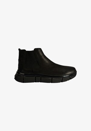 Bottines en cuir noir avec des panneaux latéraux élastiques et une semelle en caoutchouc épaisse et texturée. Finition lisse avec un bout rond et une construction durable.