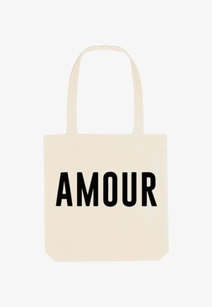 Canvas tote bag in crème kleur met het woord "AMOUR" in dikke zwarte letters gedrukt. Beschikt over twee lange handvatten voor het dragen.