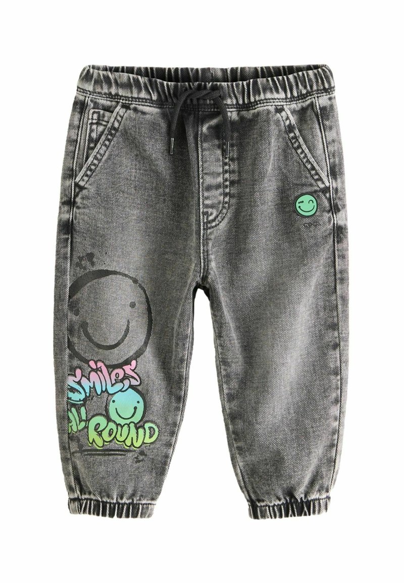 Pantalon jogger en denim gris avec taille et poignets élastiques, poches avant, et motifs colorés de smileys avec l'inscription "Smiles All Round" sur la jambe.