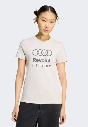 Lichtbeige katoenen T-shirt met korte mouwen, met aan de voorkant een grijs "Revolut F1 Team" logo en een ontwerp van vier onderling verbonden cirkels.