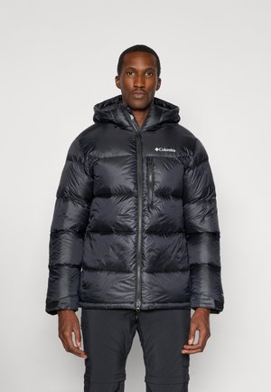 Giacca a vento nera con cappuccio, dotata di zip frontale, polsini elasticizzati e motivo trapuntato diagonale. Logo Columbia sul lato sinistro del petto.