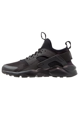 Black athletic shoe featuring mesh and synthetic materials, a cushioned sole, and a secure lace-up design with side accents.