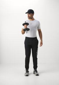 Champion ICONS CUFF PANTS LARGE LOGO - Pantalones deportivos - black
