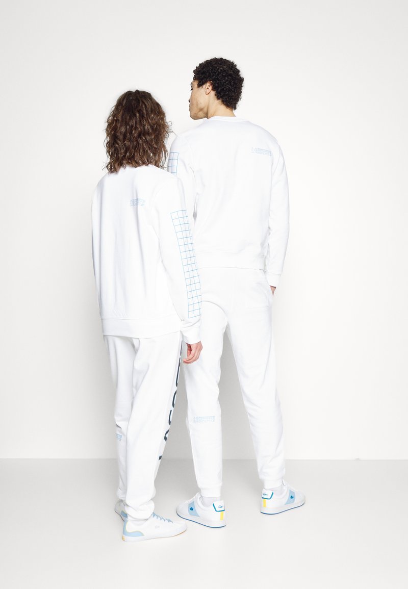 Herren Trainingsanzüge | Lacoste UNISEX EXCLUSIVE Jogginghose white/weiß - ZL22058 Herren Trainingsanzüge | Lacoste UNISEX EXCLUSIVE Jogginghose white/weiß - ZL22058