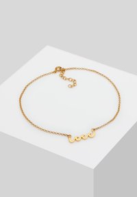 Collana in oro con pendente decorativo ondulato, caratterizzata da una finitura lucida e una chiusura regolabile per variare la lunghezza.