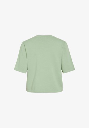 Camiseta corta de manga corta en verde claro, vista desde atrás, con cuello redondo y costuras simples.