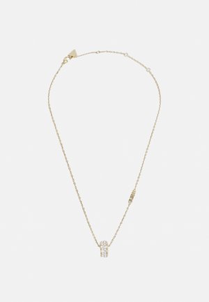 Collana in oro con pendente cilindrico testurizzato adornato con gemme trasparenti. Maglie delicate esaltano l'eleganza complessiva.