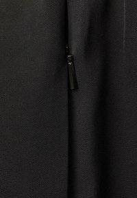 Black textured fabric with a visible zipper at the edge. The material appears durable and is finely woven with a subtle pattern.