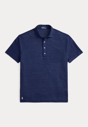 Tmavomodré polotričko zo štruktúrovanej tkaniny s golierom, zapínaním na tri gombíky a ľavým náprsným vreckom. Malé logo na leme.