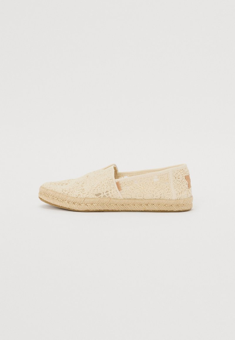 Béžové espadrilky s krajkovým potahem, kulatou špičkou a juteovou podešví. Klouby styl s prošitými detaily a minimálním označením na boku.
