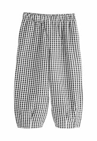 Pantalons à carreaux vichy noir et blanc avec une taille élastique, présentant une coupe ample et des poignets froncés au niveau de la cheville.