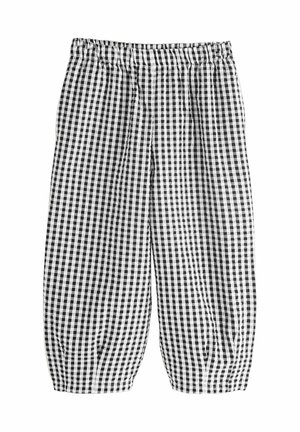 Pantalones de cuadros en blanco y negro con cintura elástica, que presentan un corte holgado y puños fruncidos en el tobillo.