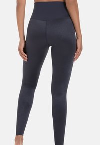 Hoch taillierte navy Leggings mit strukturiertem Muster und glatter Oberfläche. Verfügt über ein figurbetontes Design, ideal für Sportbekleidung.