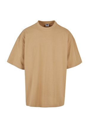Overdimensioneret beige t-shirt lavet af blød bomuld, med rund halsudskæring og korte ærmer, der har en afslappet pasform og et minimalistisk design.