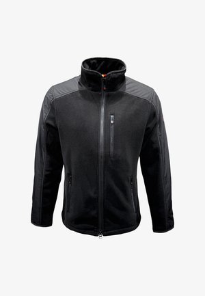 Schwarze Fleece-Jacke mit Reißverschluss, die einen hohen Kragen, Reißverschlusstaschen und Kontrastmaterial an den Schultern aufweist. Weiche Textur.