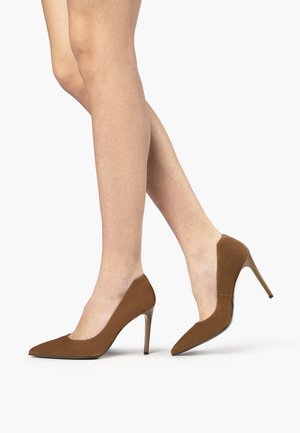 Brown suede high-heeled pumps with a pointed toe and a side cut-out design, featuring a glossy stiletto heel.