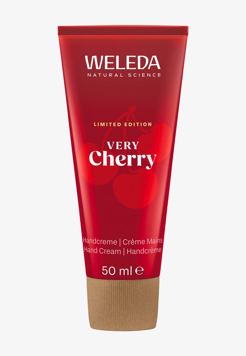 Czerwona tubka kremu do rąk Weleda z brązową podstawą, z napisem "Limitowana Edycja Bardzo Wiśniowa" oraz grafikami wiśni. Zawiera 50 ml.