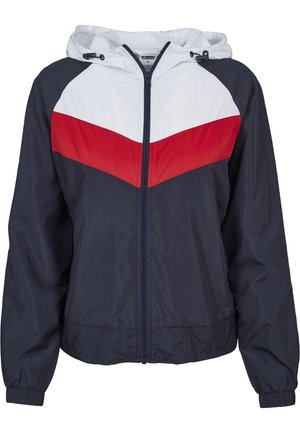 Veste à capuche bleu marine avec fermeture éclair à l'avant, poignets élastiques, et motif chevron blanc et rouge sur la poitrine et les épaules.