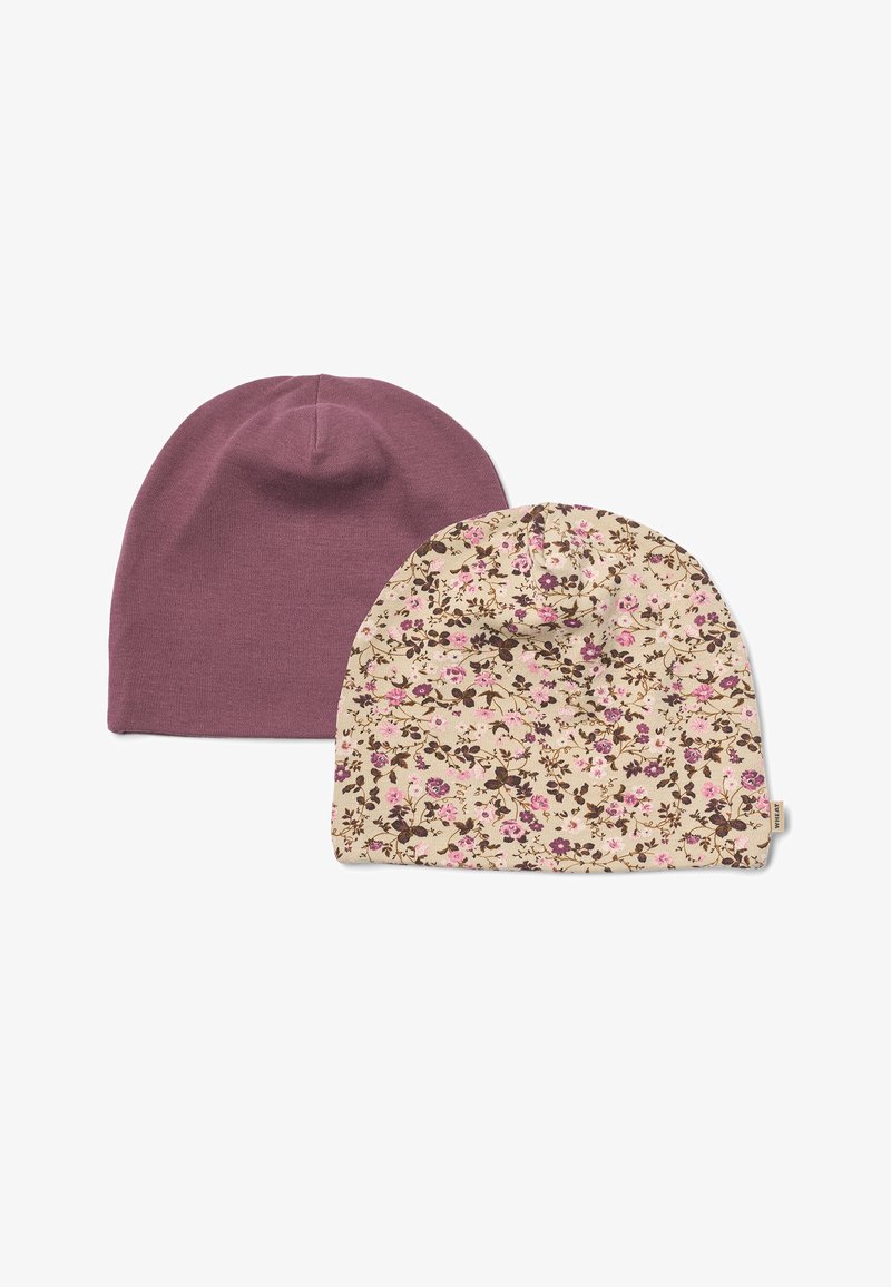 Deux bonnets en tissu doux, un uni mauve et un crème avec un petit motif floral rose et violet, présentés sur fond blanc.