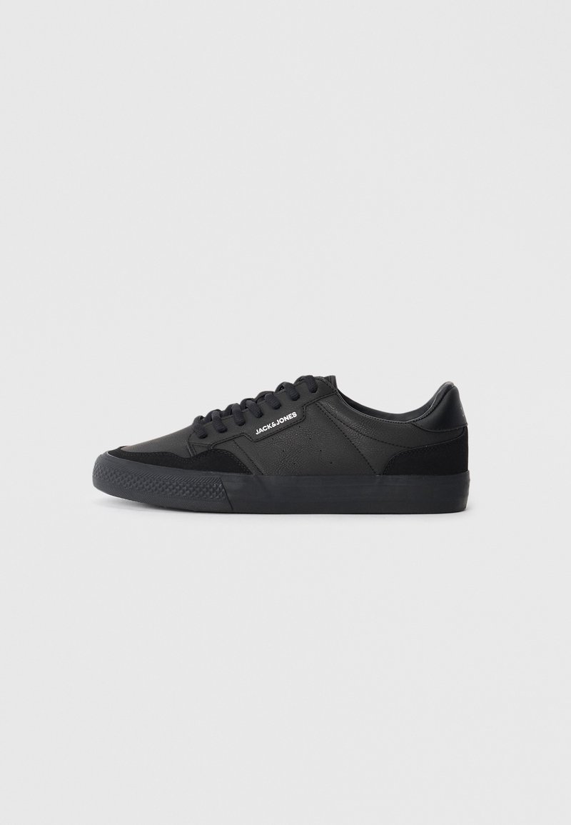 Black sneakers with a mix of leather and suede materials, featuring round laces, textured rubber sole, and a brand logo on the side.