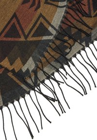 Ein gewebter Stoff mit einem geometrischen Muster in erdigen Tönen von Braun, Schwarz und Grau, mit fransigen Kanten für zusätzliche Textur.