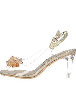 Sandales à talons transparents avec une bride métallique dorée, un dessus transparent, un accent floral en brun clair et un talon en bloc transparent de 6,5 cm.