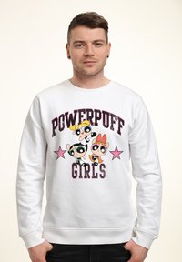 Bílá bavlněná mikina s grafikou "Powerpuff Girls", třemi postavami a růžovými hvězdami. Žebrované manžety a výstřih; volný střih.