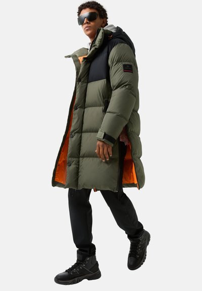 Padded long coat in olive green and black, featuring an orange lining, zip and snap closures, with side pockets and a drawstring hood.